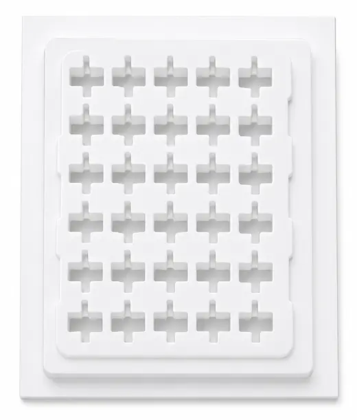 White thermoformed ESD tray of thirty cross-shaped pockets seated on its base tray, EMS Technologies